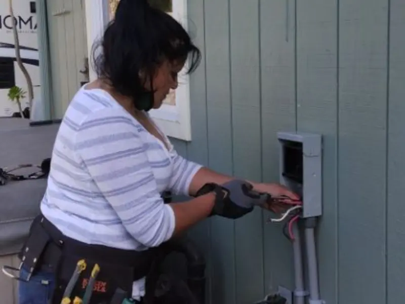 Licensed electrician wiring an exterior subpanel in St. Ann