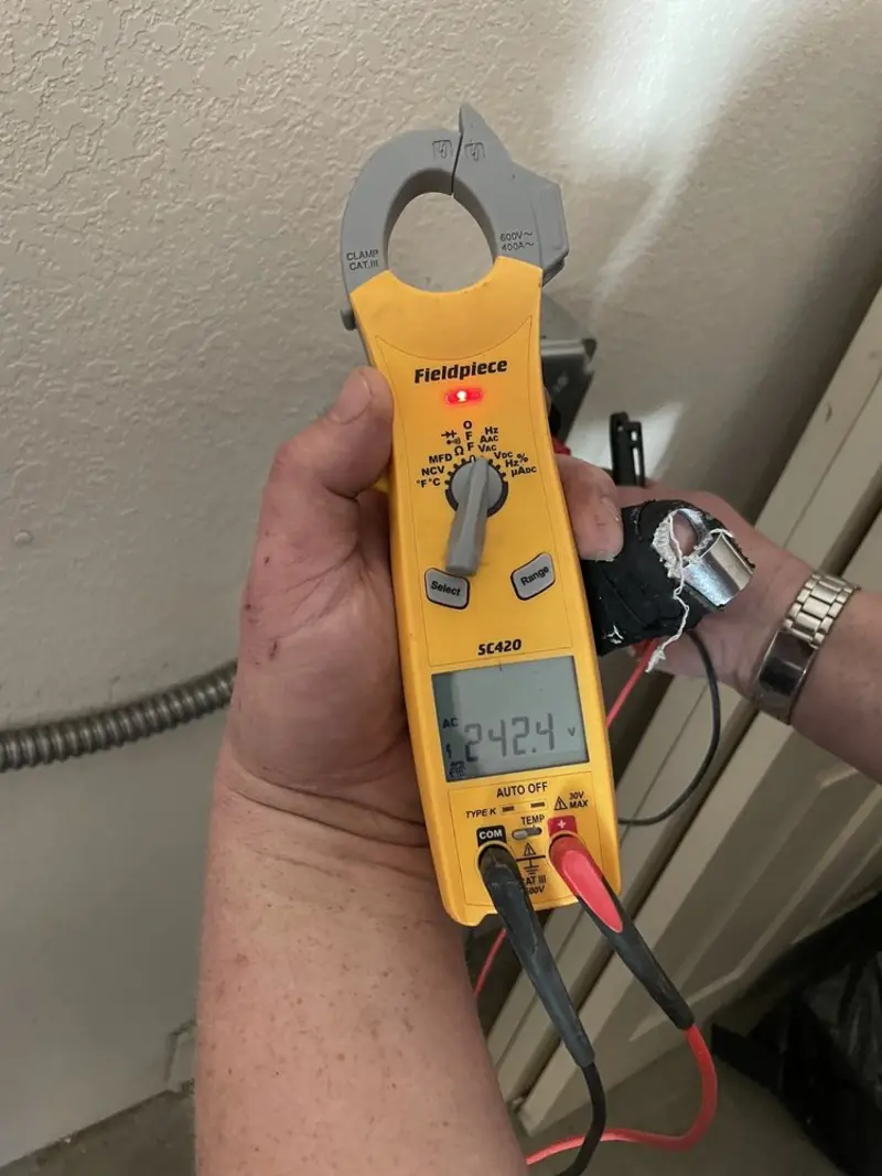 Voltage testing with clamp meter during Ceiling Fan Installation in St. Ann